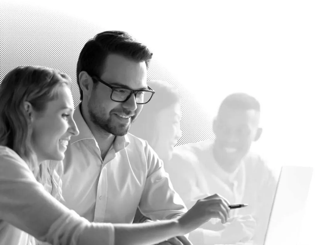 A man and woman looking at a computer screen studying Pricing University