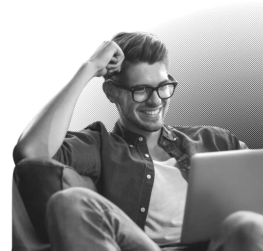 A professional man sitting in a chair with a laptop studying Pricing University
